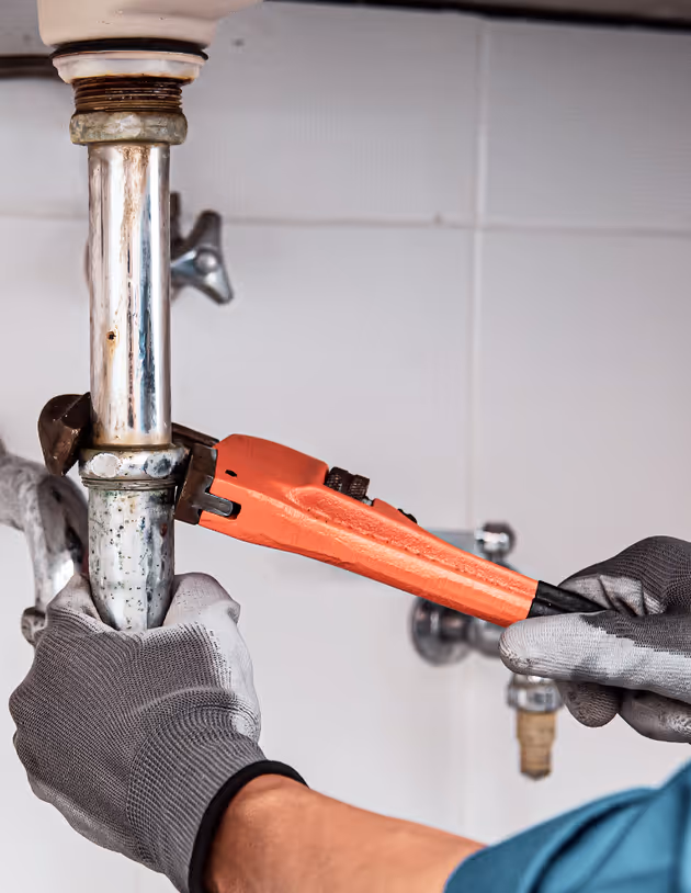 plumber working on pipe
